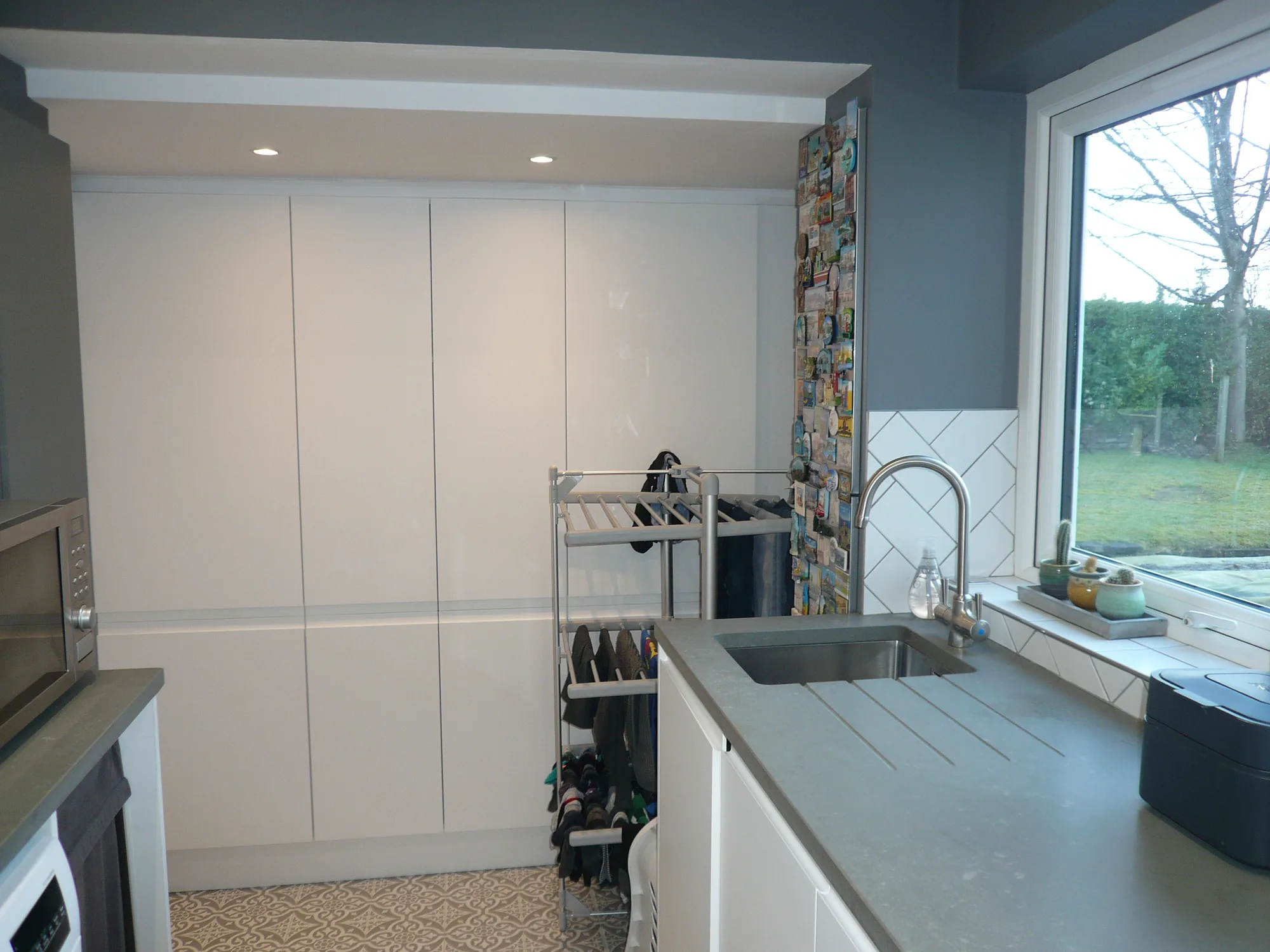 Floor to ceiling storage units in a compact fitted utility room