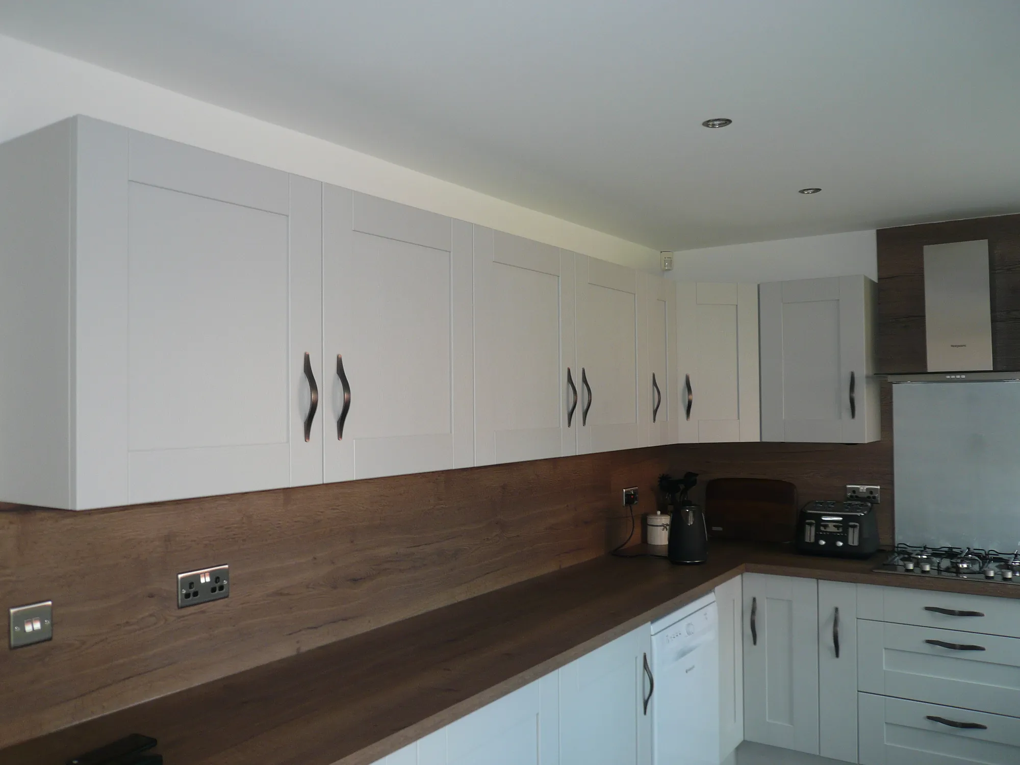 Close view of the Cartmel doors showing the timber grain and antique bronze bow handles