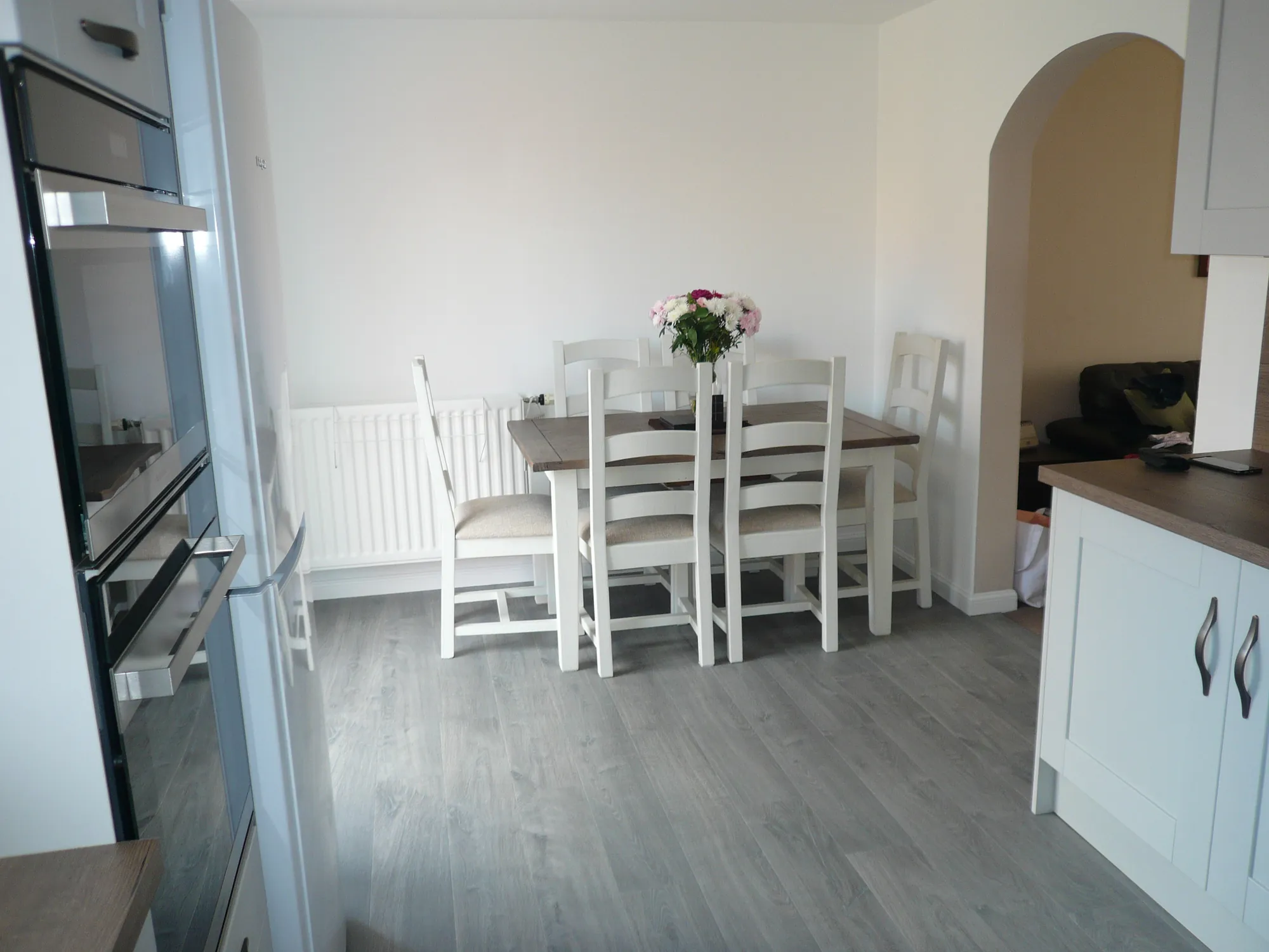 View from the new kitchen through to the dining area with white table and chairs